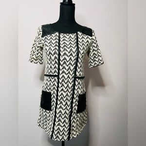 Black and white mini dress with leather-like trim and detail